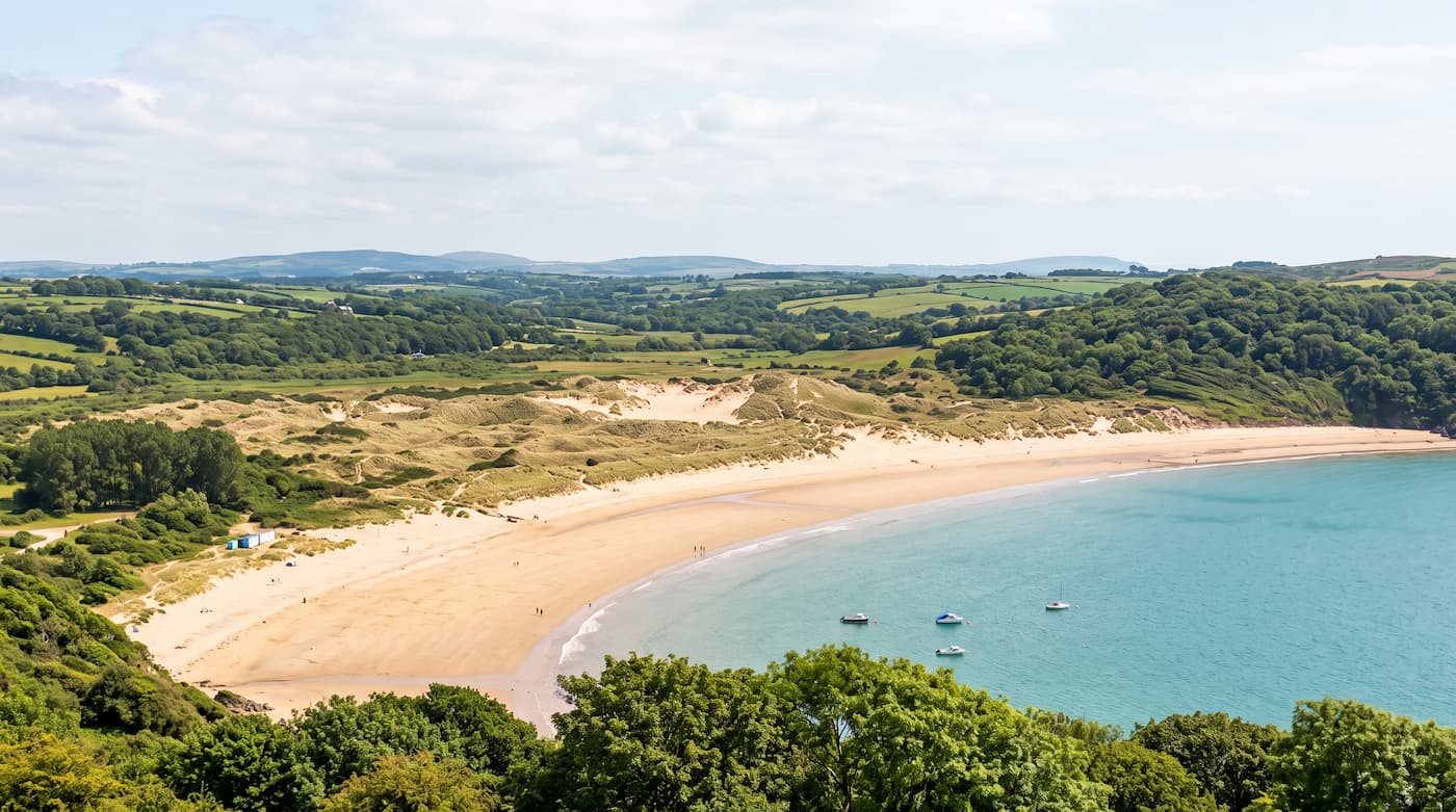 Oxwich Bay beach surrounded by woodland and countryside on the Gower Peninsula
